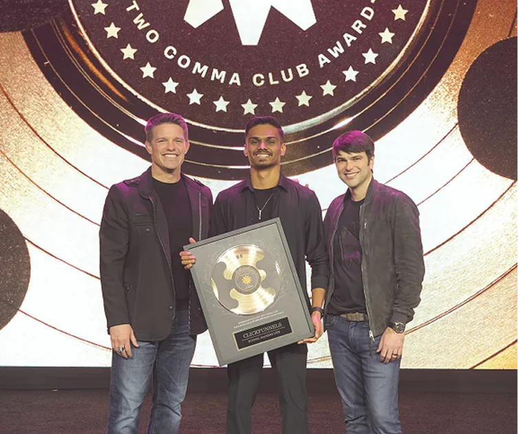 Receiving the ClickFunnels Two Comma Club award on stage
